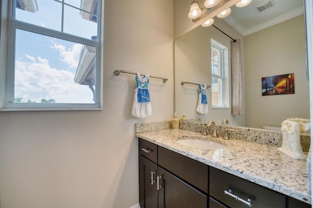 bathroom with vanity and ornamental molding