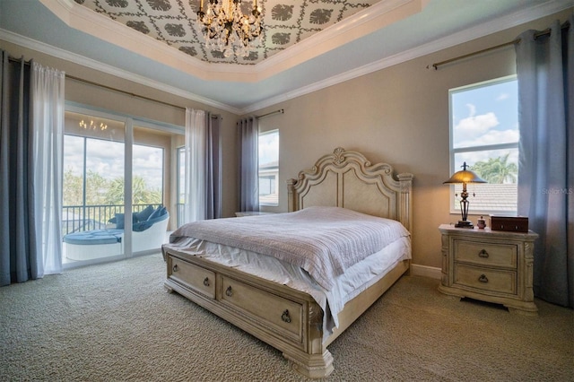 bedroom featuring light carpet, multiple windows, a tray ceiling, and access to exterior