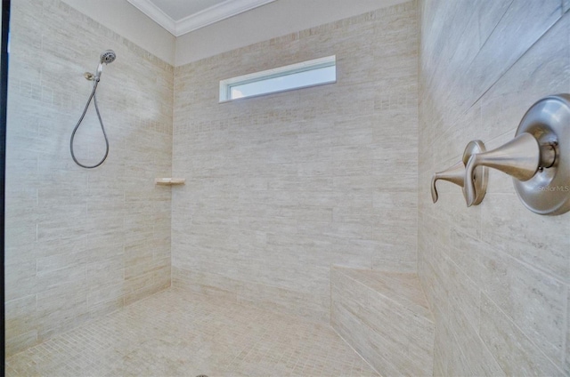 bathroom featuring tiled shower and crown molding