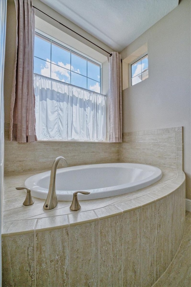 bathroom with tiled bath