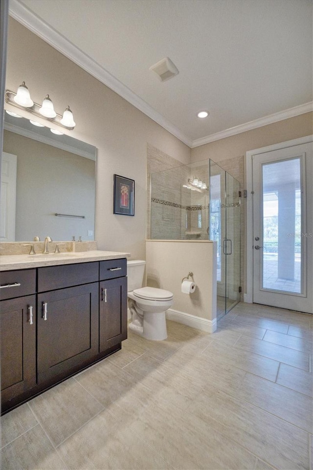 bathroom with ornamental molding, vanity, toilet, and walk in shower