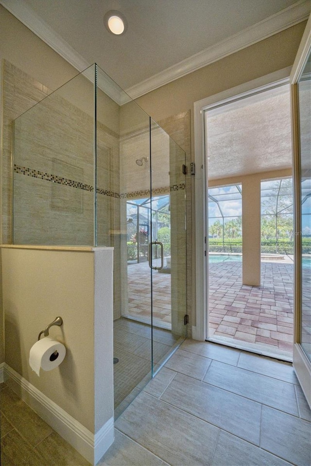 bathroom featuring an enclosed shower and crown molding