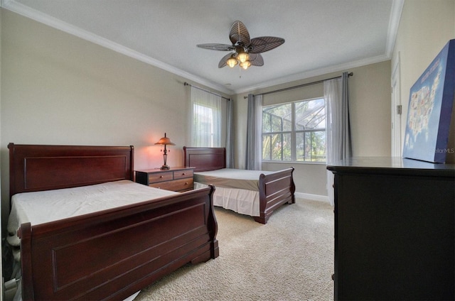 carpeted bedroom featuring ceiling fan and ornamental molding