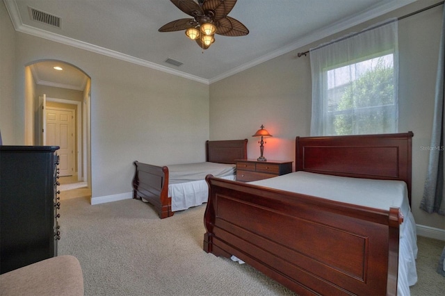 carpeted bedroom with ceiling fan and crown molding