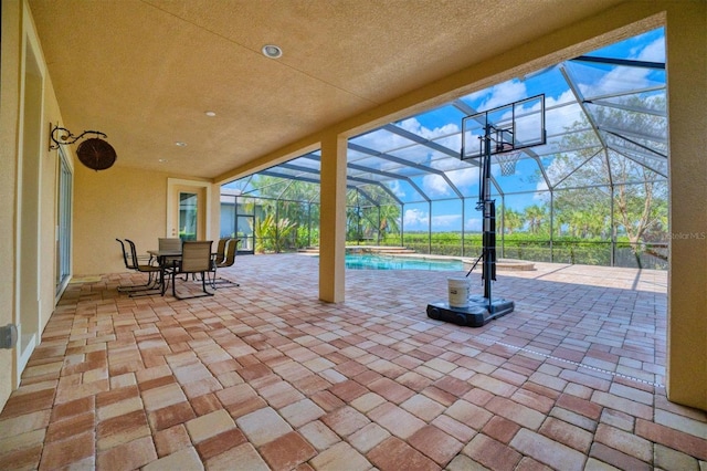 view of patio featuring a lanai