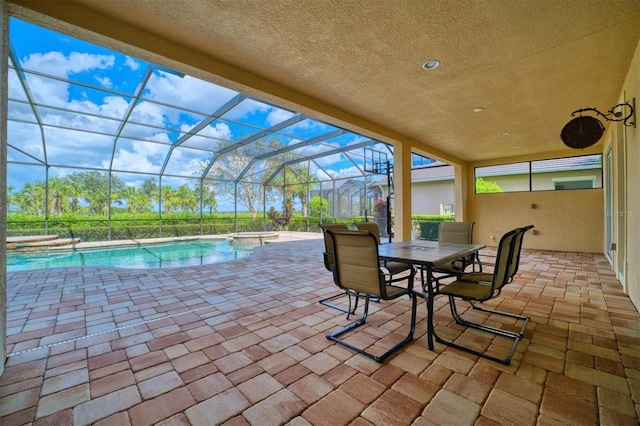 view of patio featuring a swimming pool with hot tub and a lanai