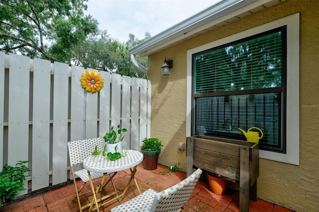 view of patio featuring fence