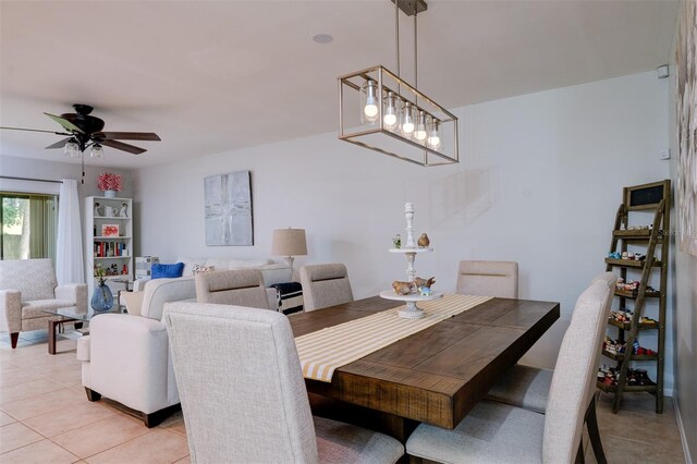 dining area featuring ceiling fan with notable chandelier and light tile patterned flooring