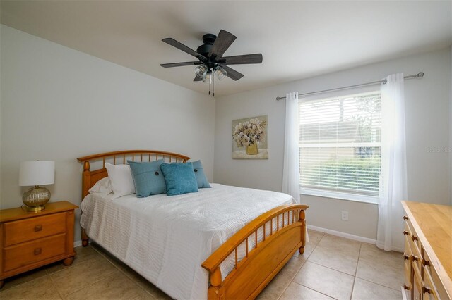 bedroom with ceiling fan and light tile patterned flooring