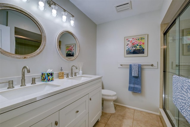 bathroom featuring tile patterned floors, walk in shower, vanity, and toilet