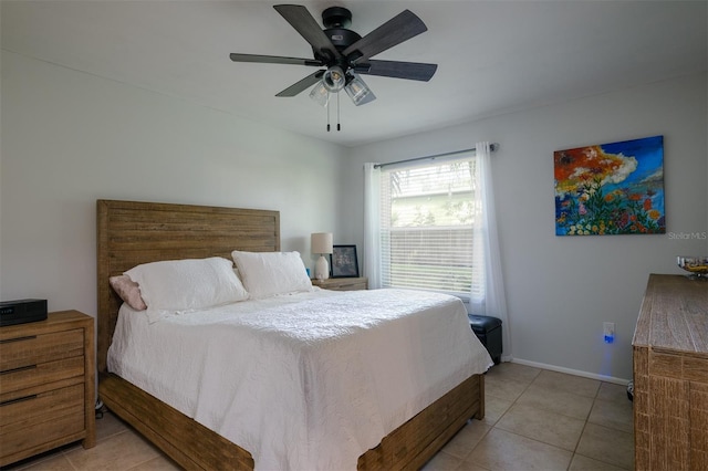 bedroom with ceiling fan, baseboards, and light tile patterned flooring