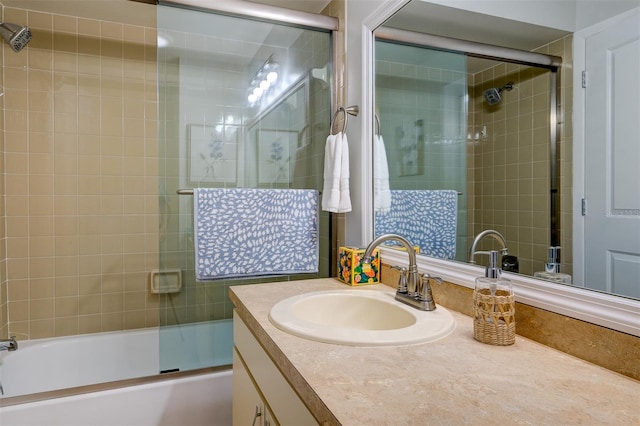 bathroom featuring shower / bath combination with glass door and vanity