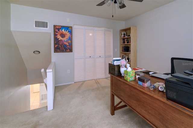 office space featuring visible vents, a ceiling fan, and carpet flooring