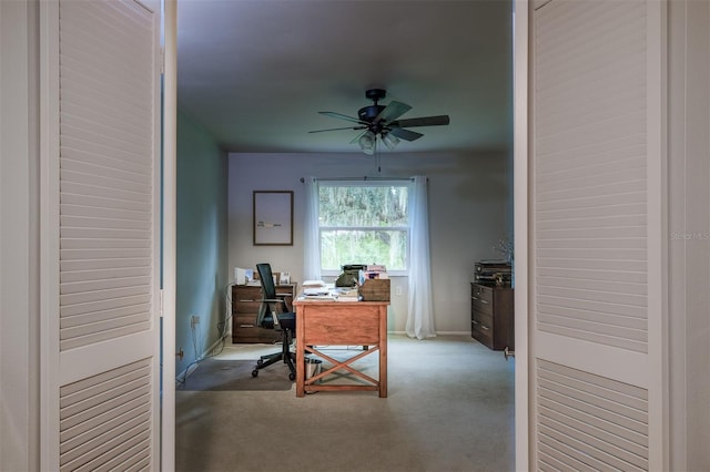 carpeted home office with baseboards and ceiling fan