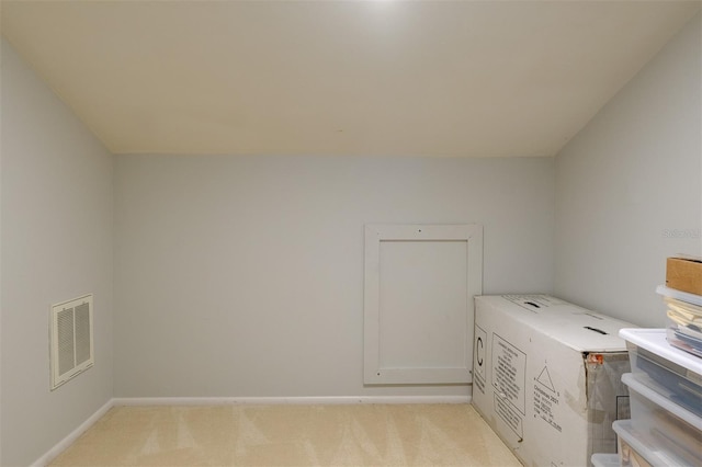 laundry area with light colored carpet