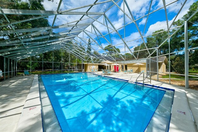 view of pool featuring a lanai and a patio