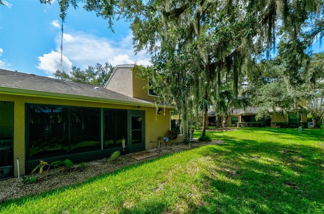 view of yard with a sunroom