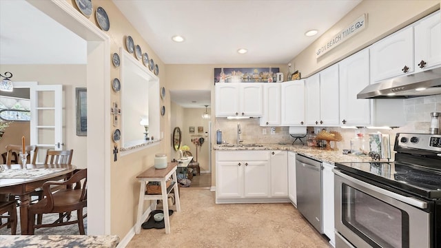 kitchen featuring stainless steel appliances, under cabinet range hood, white cabinetry, and a sink