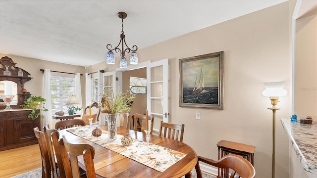 dining space with light hardwood / wood-style floors