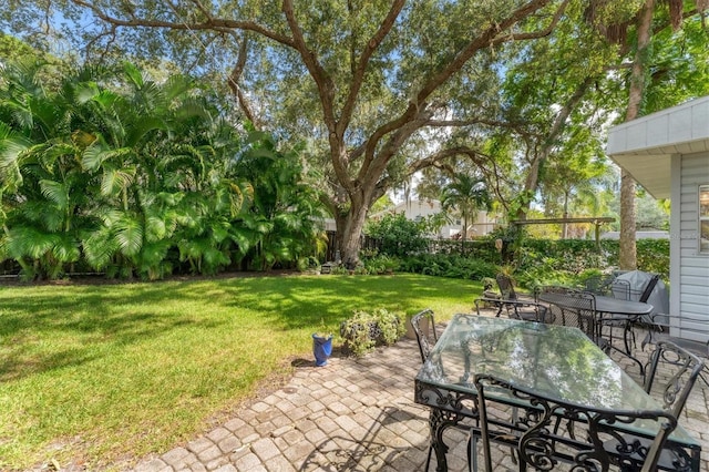 view of patio with fence and outdoor dining area