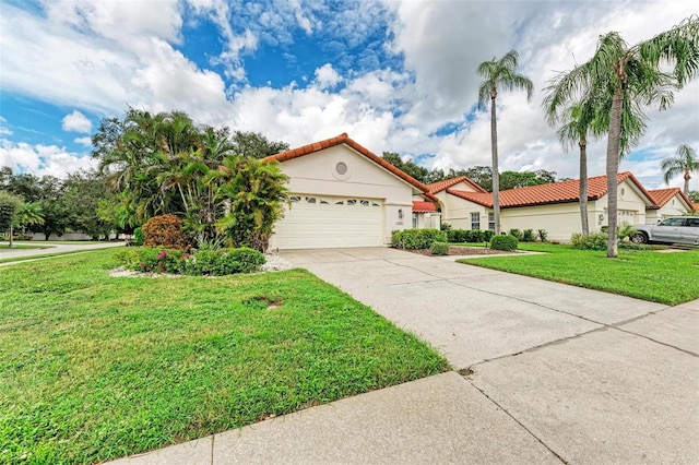 mediterranean / spanish-style house with a garage and a front lawn