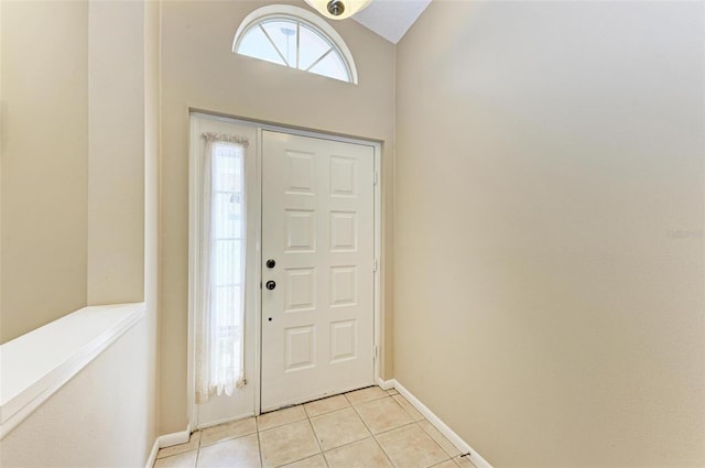 tiled entryway with vaulted ceiling