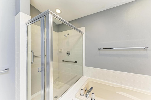 bathroom with shower with separate bathtub