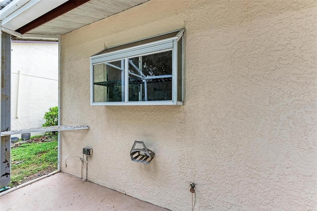 exterior space featuring concrete floors and beam ceiling