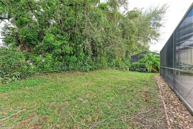 view of yard with glass enclosure