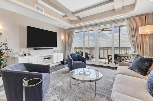 living area featuring visible vents, coffered ceiling, and wood finished floors