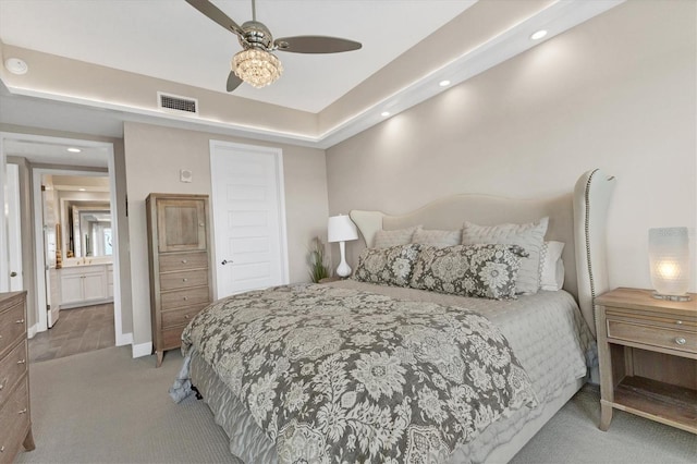 carpeted bedroom featuring ceiling fan and ensuite bathroom