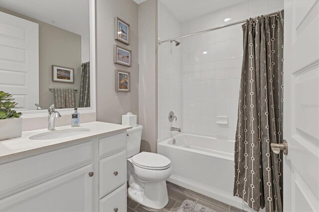 full bathroom featuring hardwood / wood-style floors, toilet, shower / bath combo with shower curtain, and vanity