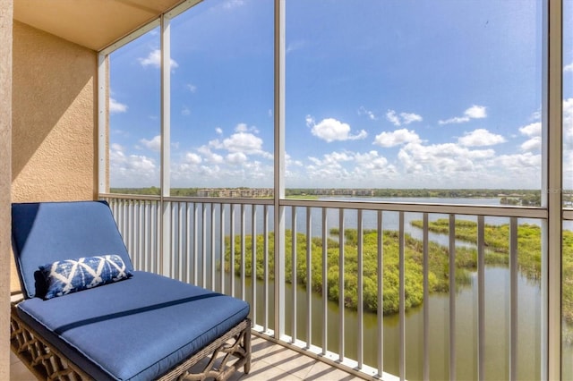 sunroom / solarium with a water view