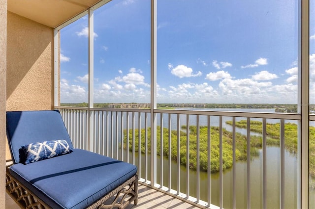 sunroom / solarium featuring a water view
