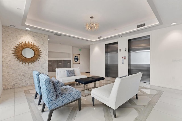 interior space with a tray ceiling, elevator, a chandelier, and light tile patterned floors