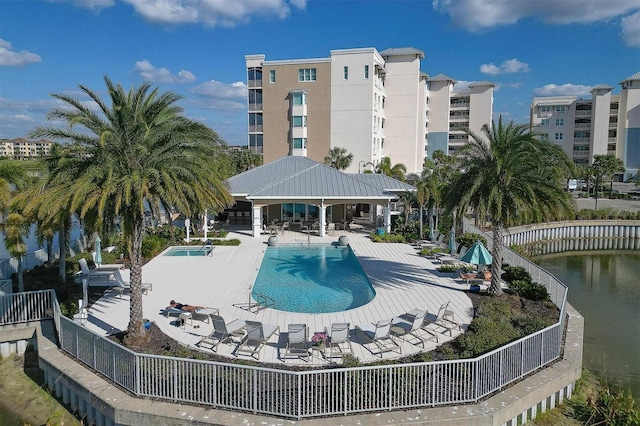 view of swimming pool featuring a gazebo, a water view, and a patio area