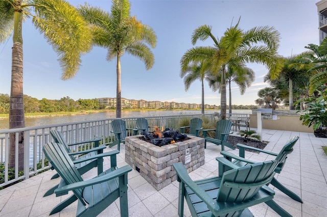 view of patio with a water view and a fire pit