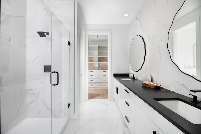 bathroom featuring vanity and a shower with door