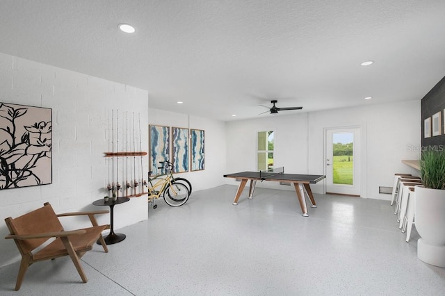 playroom with a textured ceiling and ceiling fan