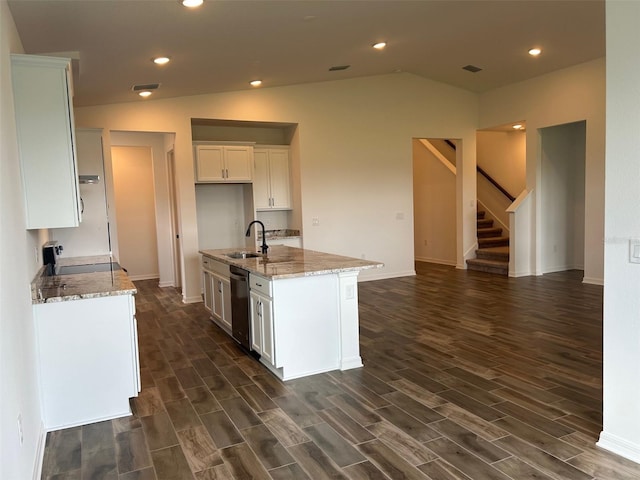 11722 Capstan Pl, Parrish, FL 34219 - kitchen with stainless steel dishwasher, dark wood-style flooring, a sink, light stone countertops, and white cabinetry