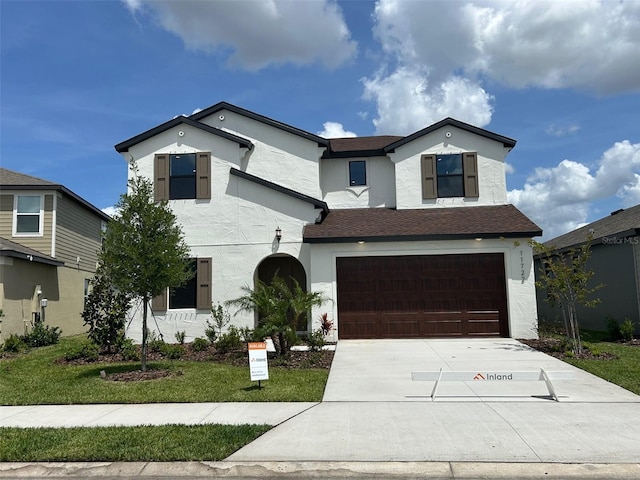 11722 Capstan Pl, Parrish, FL 34219 - traditional home featuring a garage, driveway, stucco siding, a front yard, and a shingled roof
