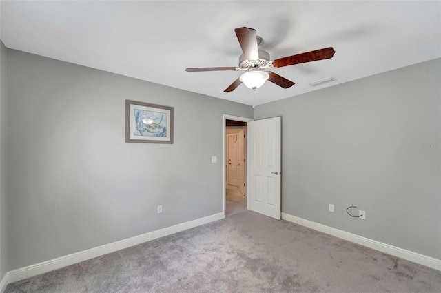 unfurnished room with ceiling fan and light colored carpet