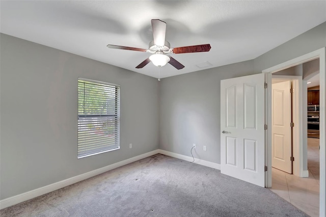 empty room with light carpet and ceiling fan