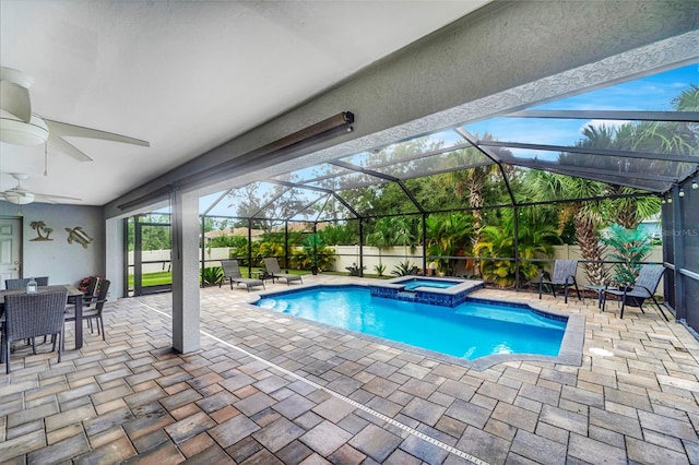 view of pool featuring a patio area, an in ground hot tub, and glass enclosure