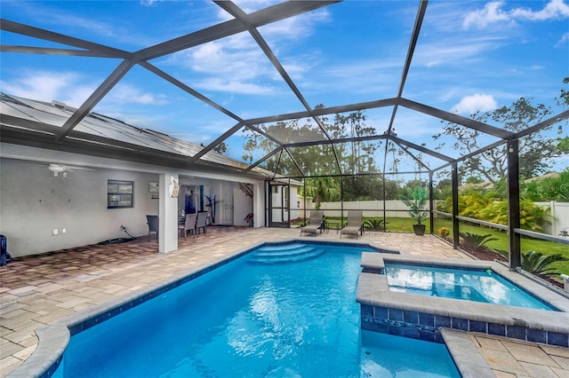 view of swimming pool with a lanai, an in ground hot tub, and a patio