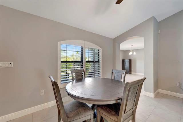 dining room with light tile patterned flooring and a chandelier