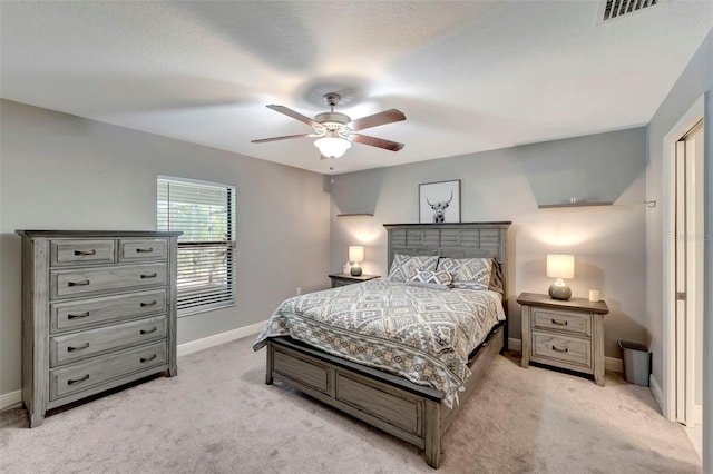 carpeted bedroom featuring a textured ceiling and ceiling fan