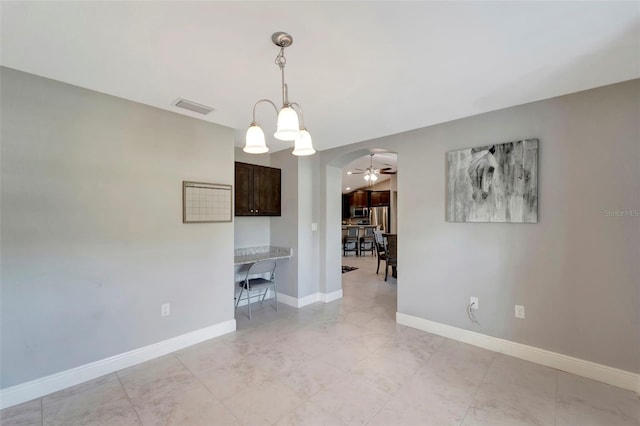 interior space with ceiling fan with notable chandelier