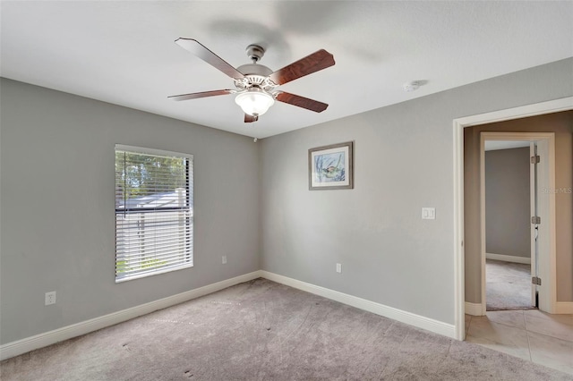 carpeted spare room with ceiling fan