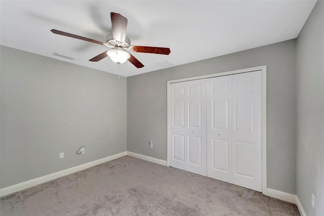 unfurnished bedroom with light carpet, a closet, and ceiling fan